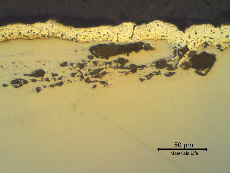 Micrographic detail of the lap at the nut surface, as polished. The 20 microns cadmium layer is evident, penetrating in the lap.