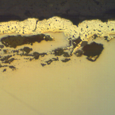 Micrographic detail of the lap at the nut surface, as polished. The 20 microns cadmium layer is evident, penetrating in the lap.