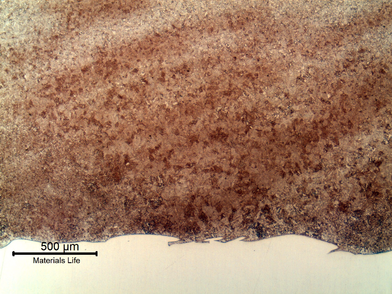 Micrography of the tubular 4130 forging at the heat affected zone (HAZ) of the Inconel overlay (white because it was not etched with the Nital). The structure is ferritic/bainitic because the overlay was conducted in two layers, and all the HAZ was reheated during welding.