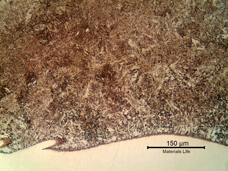 Micrography of the tubular 4130 forging at the heat affected zone (HAZ) of the Inconel overlay (white because it was not etched with the Nital). The structure is ferritic/bainitic because the overlay was conducted in two layers, and all the HAZ was reheated during welding.