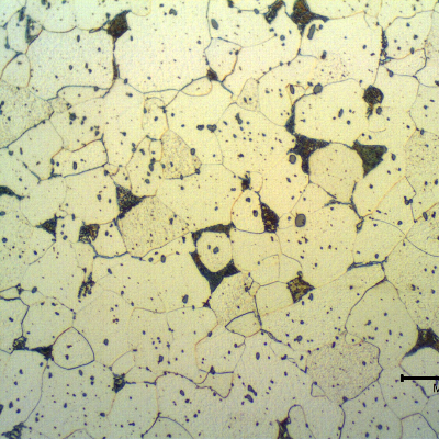 Micrographic detail of the transverse section of the fitiing, in a free-cutting steel.  The microstructure is predominantly ferritic, some perlitic areas and free cementite at ferritic grain boundaries.  There is a large amount of  inclusions, that appear as spots.