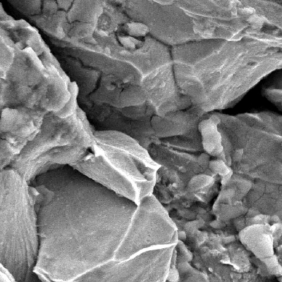 Details of the intergranular fracture, probably associated to cementite at grain boundaries.