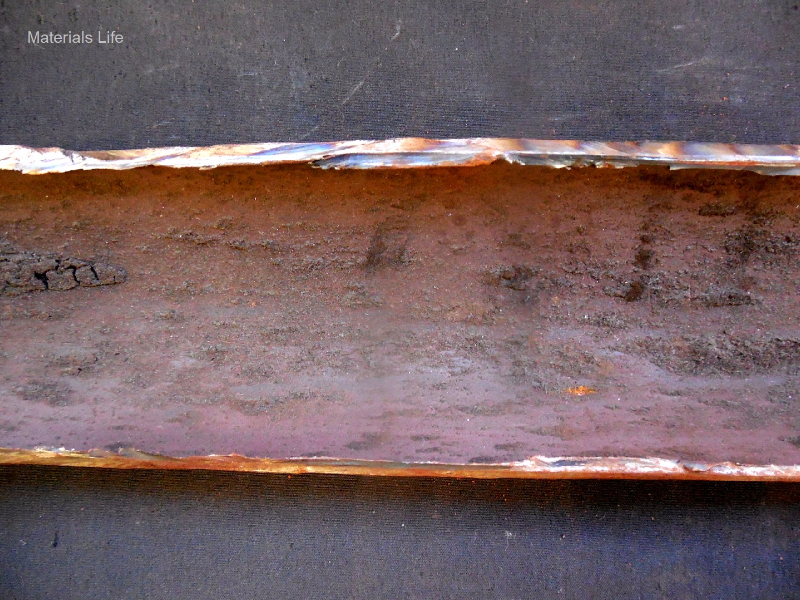 Aspect of the internal surface of the tube after longitudinal cut. 
This position is out of the damage area and only a small amount of deposits is evident.