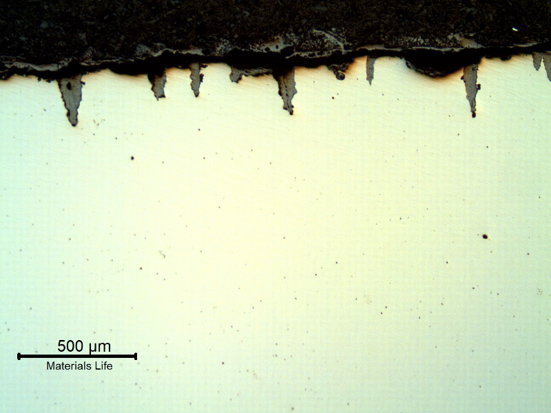 The micrography of the longitudinal section of the tube, close to OD, shows the paralel cracks, filled with oxides, perpendicular to the surface.