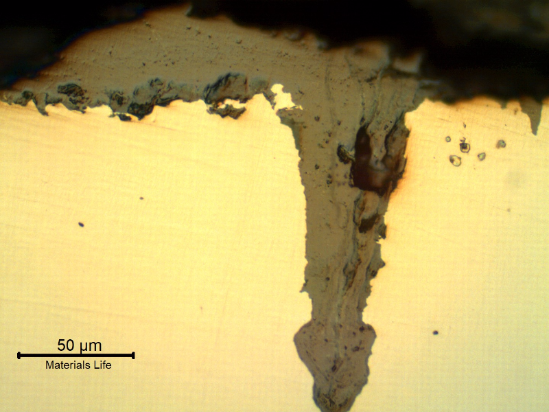 Micrographic details of the longitudinal section of the tube, close to OD, showing paralel cracks, filled with oxides, perpendicular to the surface.