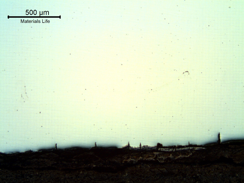 The micrography of the longitudinal section of the tube, close to ID, shows the paralel cracks, filled with oxides, perpendicular to the surface.