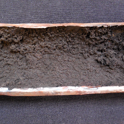 Aspect of the internal surface of the tube after longitudinal cut. 
This position is at the damage area where a thick deposit is evident.