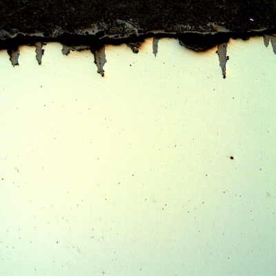 The micrography of the longitudinal section of the tube, close to OD, shows the paralel cracks, filled with oxides, perpendicular to the surface.