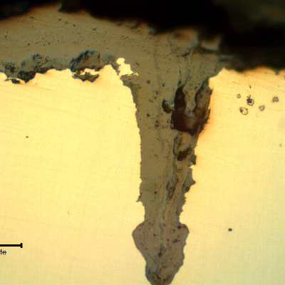 Micrographic details of the longitudinal section of the tube, close to OD, showing paralel cracks, filled with oxides, perpendicular to the surface.
