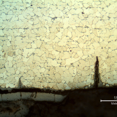 Micrography of the longitudinal section of the tube, close to ID, showing the cracks from the surface.  The cracks are filled with oxides and there is still a layer of oxides at the internal surface, detached from the surface (probably during cleaning).