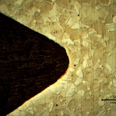 Low magnification micrography of the bolt in a longitudinal section, at the bolt thread, showing no evidences of forming operations, indicating it was machined from a heat treated bar. 
Austenitic microstructure, granular, equiaxial, precipitation hardened (shadow in the grains).