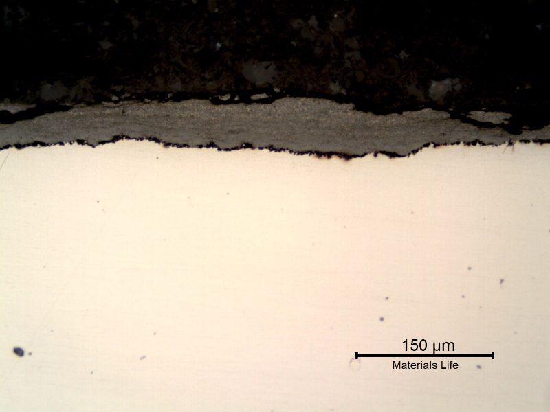 Micrography of the longitudinal section of the tube, close to the external surface, presenting a thick deposit.