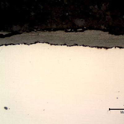 Micrography of the longitudinal section of the tube, close to the external surface, presenting a thick deposit.