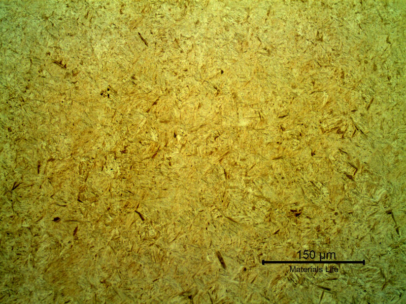 Micrography of the shaft at the surface, in a region where a thermal spray layer was not applied.  The microstructure at the shaft surface is martensitic (low carbon martensite) typical of a quenched and tempered condition for this low alloy steel.  The heat treatment was probably conducted before the thermal spray layer was applied.