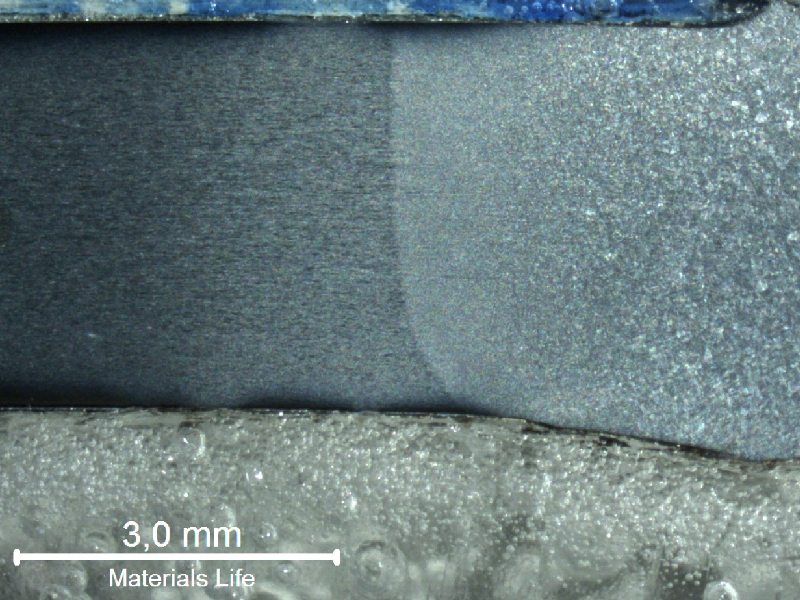 Macrography of a longitudinal section of a 4 mm diameter wire, presenting part of an austogenously welded joint, with the transformation of the strain hardened pearlitic.  The base metal is to the left side of the figure, and the heat affected zone is in the center of the figure.  There is a (previous austenite) grain growth to the right side of the figure, where it is the center of the weld.