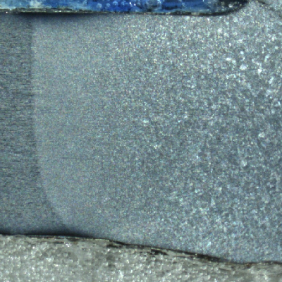 Macrography of a longitudinal section of a 4 mm diameter wire, presenting part of an austogenously welded joint, with the transformation of the strain hardened pearlitic.  The base metal is to the left side of the figure, and the heat affected zone is in the center of the figure.  There is a (previous austenite) grain growth to the right side of the figure, where it is the center of the weld.