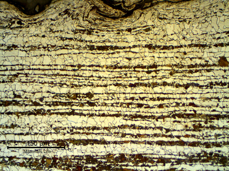 Micrography of a transverse section of the tubing, at the external surface.
Ferritic-pearlitic structure. The roughness of the surface is high because the structure was painted and a blasting treatment was probably applied to the surface to improve adherence.