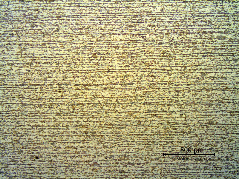 Low magnification micrography of a transverse section of the tubing, in the center of the thickness.  Banded structure, ferritic-pearlitic.