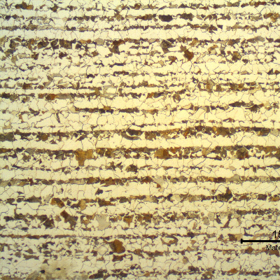 Micrography of a transverse section of the tubing, in the center of the thickness. Ferritic-pearlitic structure. Bands of pearlite colonies. Refined grains.