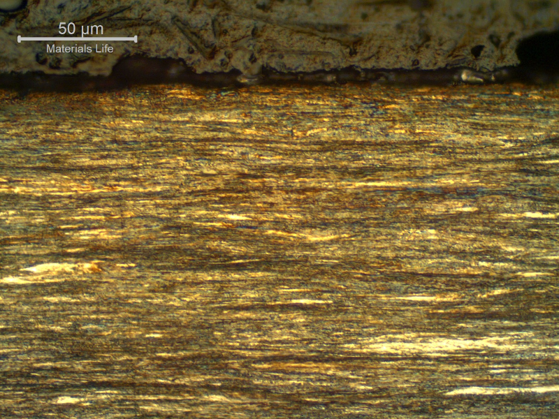 Micrographic detail of a longitudinal section of the strand external layer, wire 3.8 mm diameter, at the surface, showing that it presents no protective layer (not galvanized nor plated) and the microstructure is pearlitic, strain hardened.