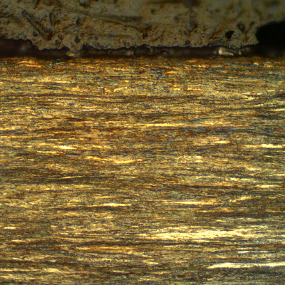 Micrographic detail of a longitudinal section of the strand external layer, wire 3.8 mm diameter, at the surface, showing that it presents no protective layer (not galvanized nor plated) and the microstructure is pearlitic, strain hardened.