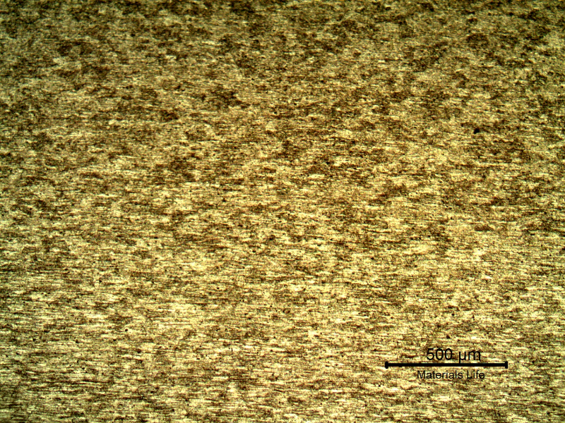 Low magnification micrography of the plate base metal, presenting granular structure not clearly identified and aligned particles.