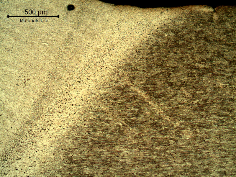 Low magnification micrography of the welded joint at the heat affected zone of the flat position, in the last bead (face). Longitudinal section of the plate, transverse to the welded joint.