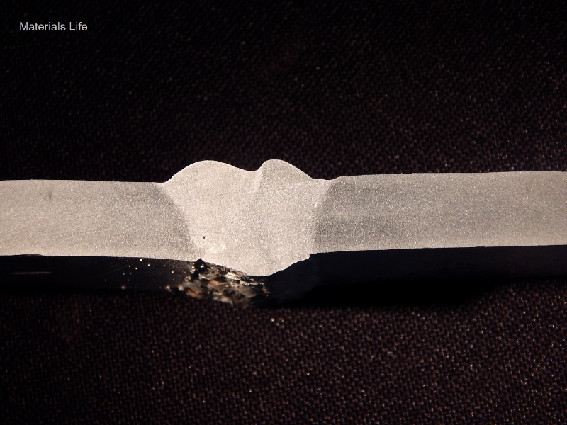 Macrography of the vertical up position welded joint. It was welded in three passes, with the following parameters.   
Root pass - 115A, 21V, 162mm/s (wire speed), 2.6 mm/s (welding speed), 1090 J/mm.  
Second pass - 143A, 21V, 162mm/s (wire speed), 5.5 mm/s (welding speed), 594 J/mm.  
Third pass - 144A, 21V, 162mm/s (wire speed), 6.1 mm/s (welding speed), 979 J/mm.