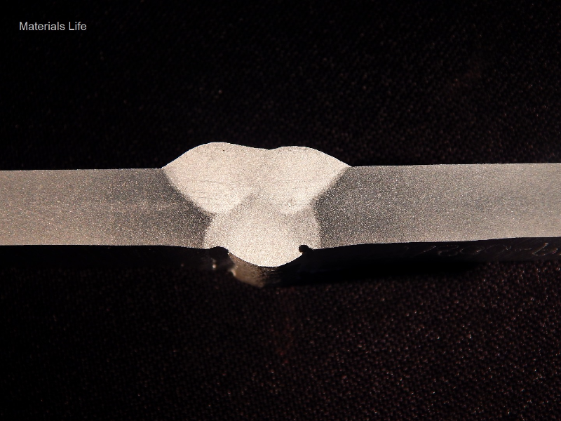 Macrography of the flat position welded joint. It was welded in three passes, with the following parameters.
Root pass - 159A, 21V, 147mm/s (wire speed), 3.5 mm/s (welding speed), 979 J/mm.
Second pass - 170A, 22V, 168mm/s (wire speed), 7.7 mm/s (welding speed), 538 J/mm.
Third pass - 172A, 23V, 168mm/s (wire speed), 7.0 mm/s (welding speed), 587 J/mm.