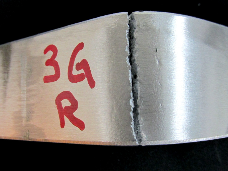 Broken bending testpiece of the 3G position. The presence of cracks at the root caused the lack of material ductility and opening of cracks during bending. The procedure was not qualified.