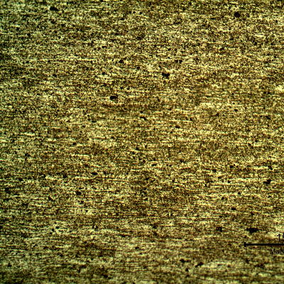 Micrography of the plate base metal, presenting granular structure evidenced by the different shadows in the grains.