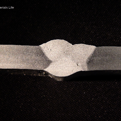 Macrography of the horizontal position joint. It was welded in three passes, and one additional pass from the root.   
Root pass - 153A, 20V, 156mm/s (wire speed), 3.5 mm/s (welding speed), 933 J/mm.  
Second pass - 162A, 20V, 156mm/s (wire speed), 5.8 mm/s (welding speed), 592 J/mm.  
Third pass - 155A, 19V, 156mm/s (wire speed), 5.9 mm/s (welding speed), 523 J/mm.  
Additional at the root - 161A, 23V, 187mm/s (wire speed), 8.5mm/s (welding speed), 467J/mm.
