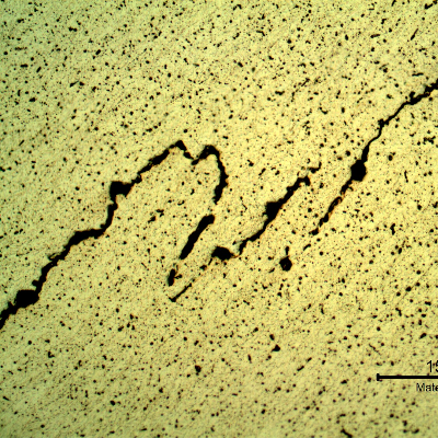 Micrography of the welded joint, at the root, showing hot cracks with intergranular morphology.