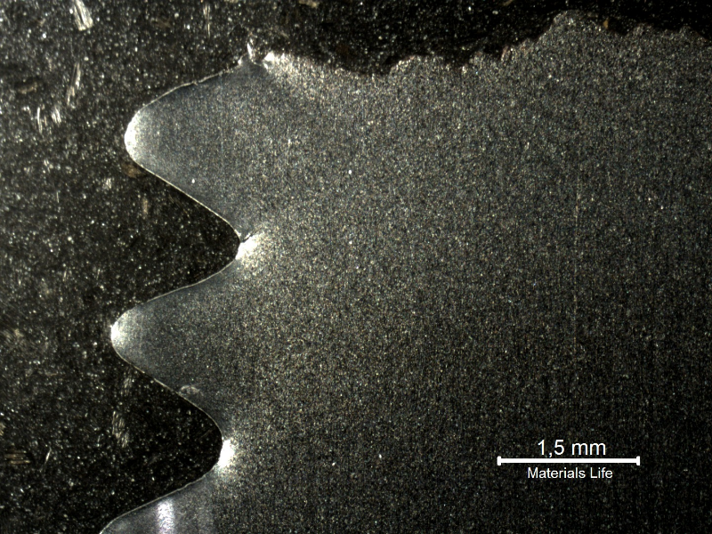 Macrography of a longitudinal section of the eye bolt, presenting the fracture in the top of the figure and the threads in the left side of the figure. Details of the fracture of the first thread fillet below the fracture are presented in the next figures.