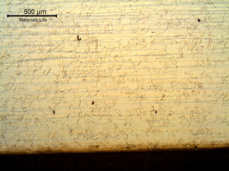 Nitronic 60 cylinder. Micrography of the longitudinal section close to the surface, presenting a fully austenitic microstructure, with a shadow close to the external surface that is associated to a small layer of strain hardened structure (deformation twins).