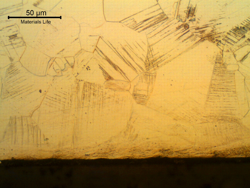 Nitronic 60 cylinder. Micrographic detail of the longitudinal section close to the surface, presenting a fully austenitic microstructure, with a layer of strain hardened structure (deformation twins).
