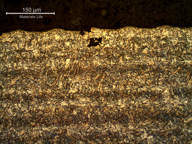 17-4 PH rod. Micrography of the longitudinal section close to the surface, presenting the roughness (the waves at the surface) and a region where a pitting was still in the beginning, not related to any specific microstructure.