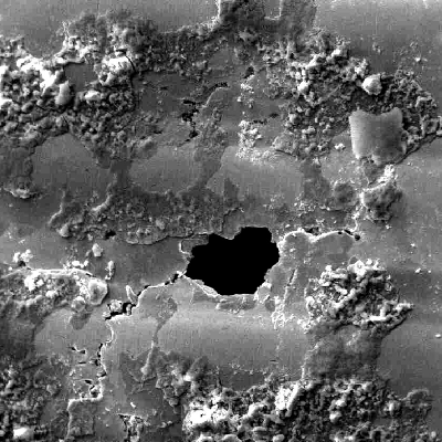 17-4 PH rod. Surface aspect by scanning electron microscopy showing a region where the passivation layer was destroyed and a pitting was in the begining.