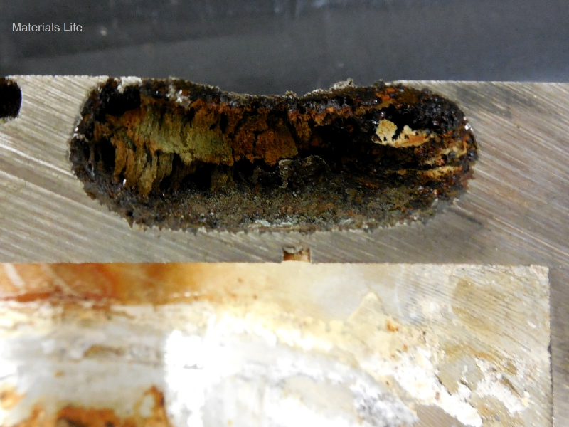 Detail of the case thickness (20 mm) with the through wall localized corrosion in a crevice condition where there was a plug.