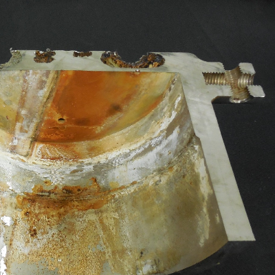 After a longitudinal cut of the case it was possible to see that a localized corrosion has occurred associated to the regions where there were sealed holes, plugged, in a crevice condition, not related to any welded position.