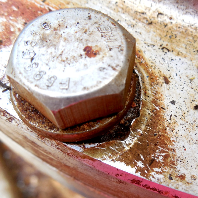 Aspect of a crevice corrosion of the flange, under the bolt head, showing evidences that the cathodic protection system was not connected to the stainless steel instrument.