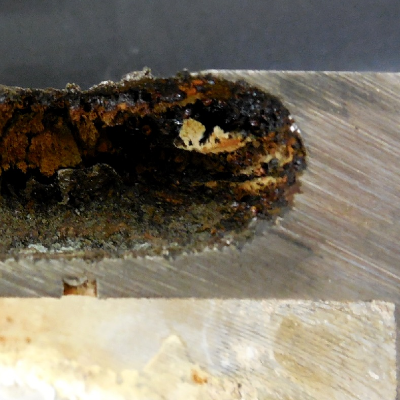 Detail of the case thickness (20 mm) with the through wall localized corrosion in a crevice condition where there was a plug.