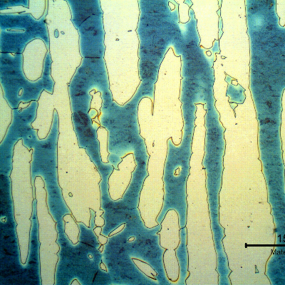 Micrography of a longitudinal section of the forged bar in the center of the thickness. Ferrite and austenite.  The average austenite spacing is 80 microns, a lot larger than the maximum allowed in the specification, of 30 microns.  No detrimental phases were identified at the ferrite/austenite interfaces, but the ferrite phase presented a rough aspect. Higher magnification analysis would be required to identify precipitation.