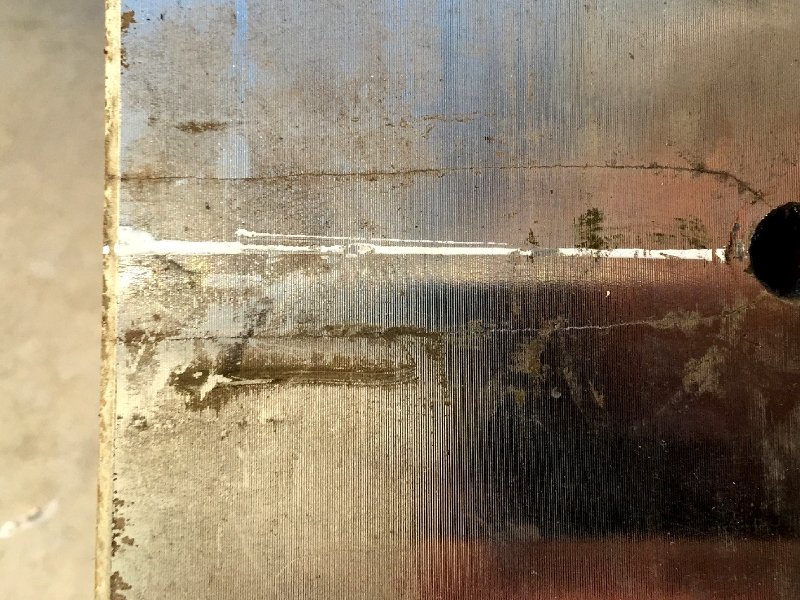 Macroscopic aspect of the crack in the valve ring surface. A leakage was detected during testing after 6 months out of service and the inspection identified several transverse cracks in the forged ring.  The valve was installed for one year, but it was not drained during the time it was out of service. The cracks were located in regions that were rusted and presenting a biological fouling.