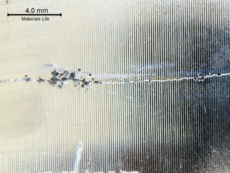 Macroscopic aspect of the crack after cleaning the ring surface. Transverse cracks were identified associated to pitting corrosion.