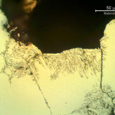 Micrographic detail of a transverse section of the ring, showing the corroded martensitic structure (chemical dissolution) inside the pitting.