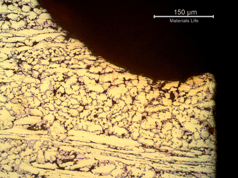 Micrographic detail of the dezincification effect, where the beta phase is preferentially corroded, leaving a cooper rich phase (red) that is porous and easily cracks.