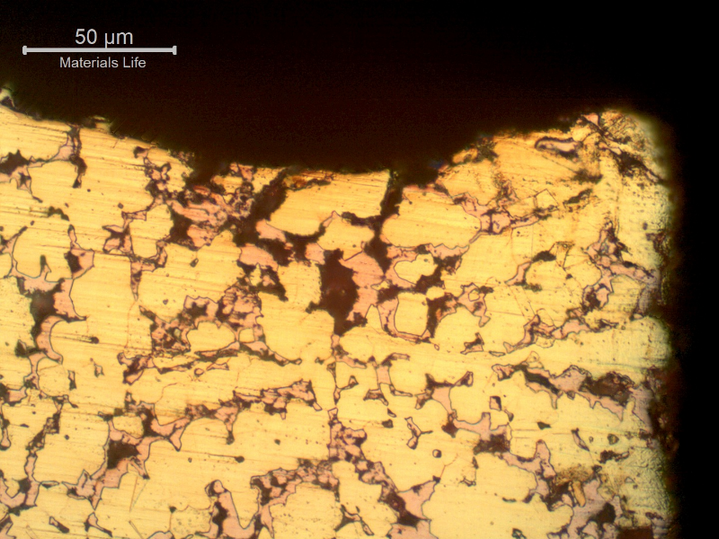 Micrographic detail of the dezincification effect, where the beta phase is preferentially corroded, leaving a cooper rich phase (red) that is porous and easily cracks.