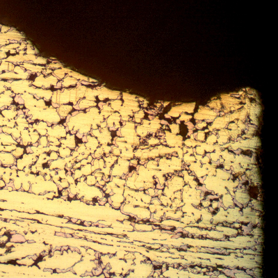 Micrographic detail of the dezincification effect, where the beta phase is preferentially corroded, leaving a cooper rich phase (red) that is porous and easily cracks.
