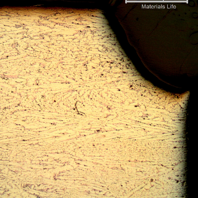 Micrography of the transverse section of the platesheet showing that part of the material (right side in the top of the figure) was lost (corroded).